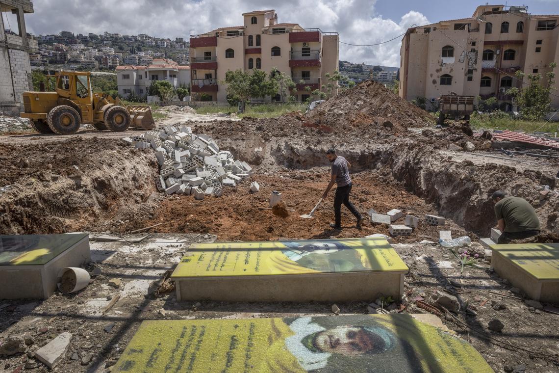 Workers dig near the graves of Hezbollah members in a damaged cemetery in the southern Lebanese village of Mansouri, on Tuesday, April 21, 2026. The U.S. State Department will host a second round of ambassador-level talks between Israel and Lebanon, which are in a cease fire, on Thursday, the department said. (David Guttenfelder/The New York Times)