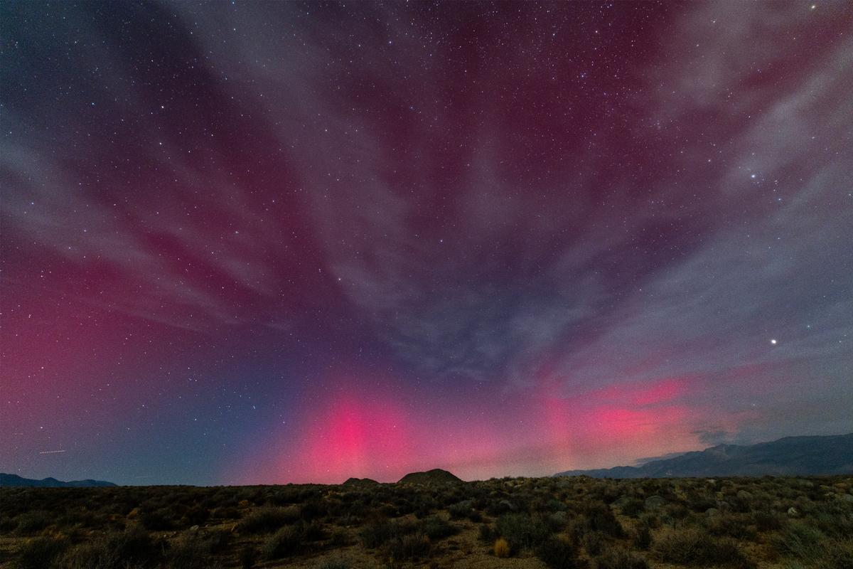 The northern lights make a rare appearance from Owens Valley and Eastern Sierra mountains on October 10, 2024 near Bishop, California. 