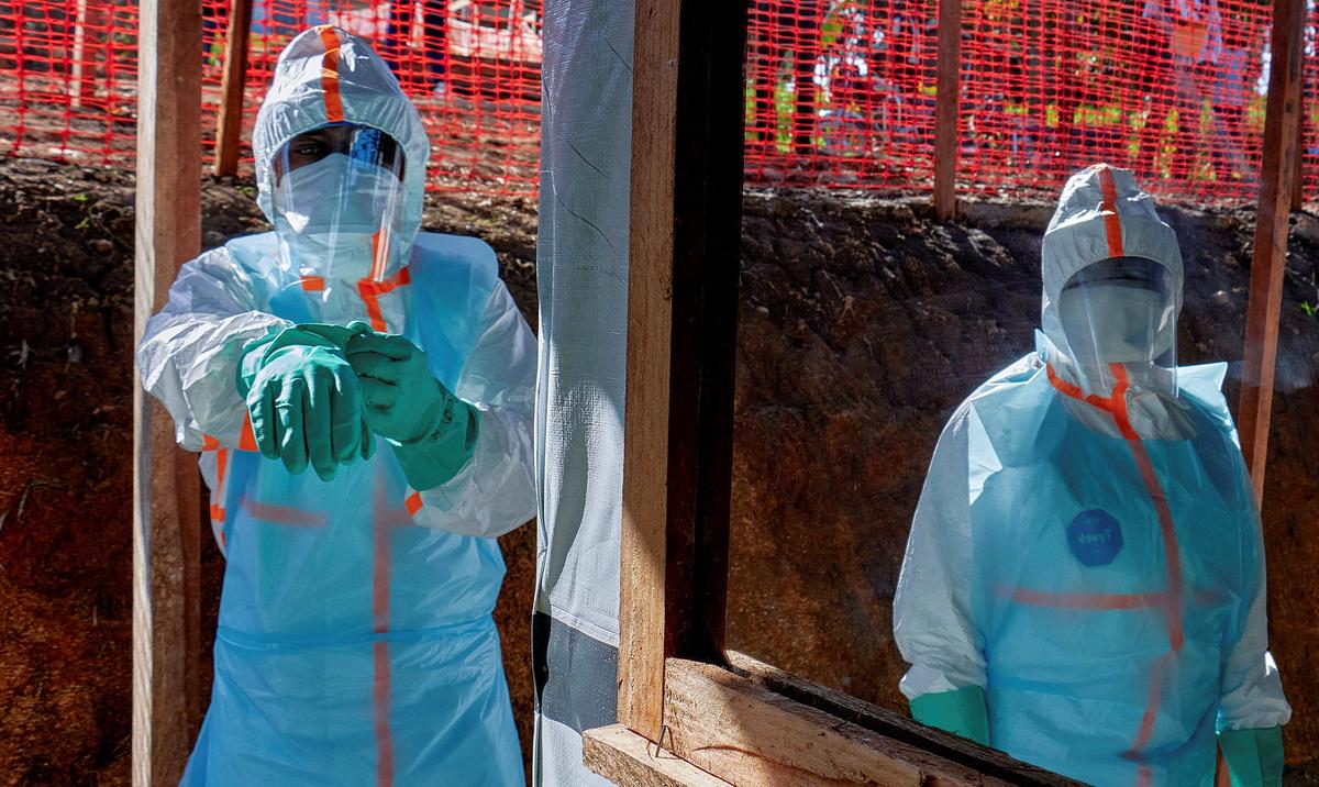 Health workers get dressed in personal protective equipment (PPE) at the Evangelical Medical Center, one of the facilities at the forefront of the response to the Ebola outbreak, as agencies intensify efforts to contain a new Ebola outbreak caused by the Bundibugyo virus strain, in Bunia, Ituri province, Democratic Republic of Congo, May 31, 2026. REUTERS/Gradel Muyisa Mumbere