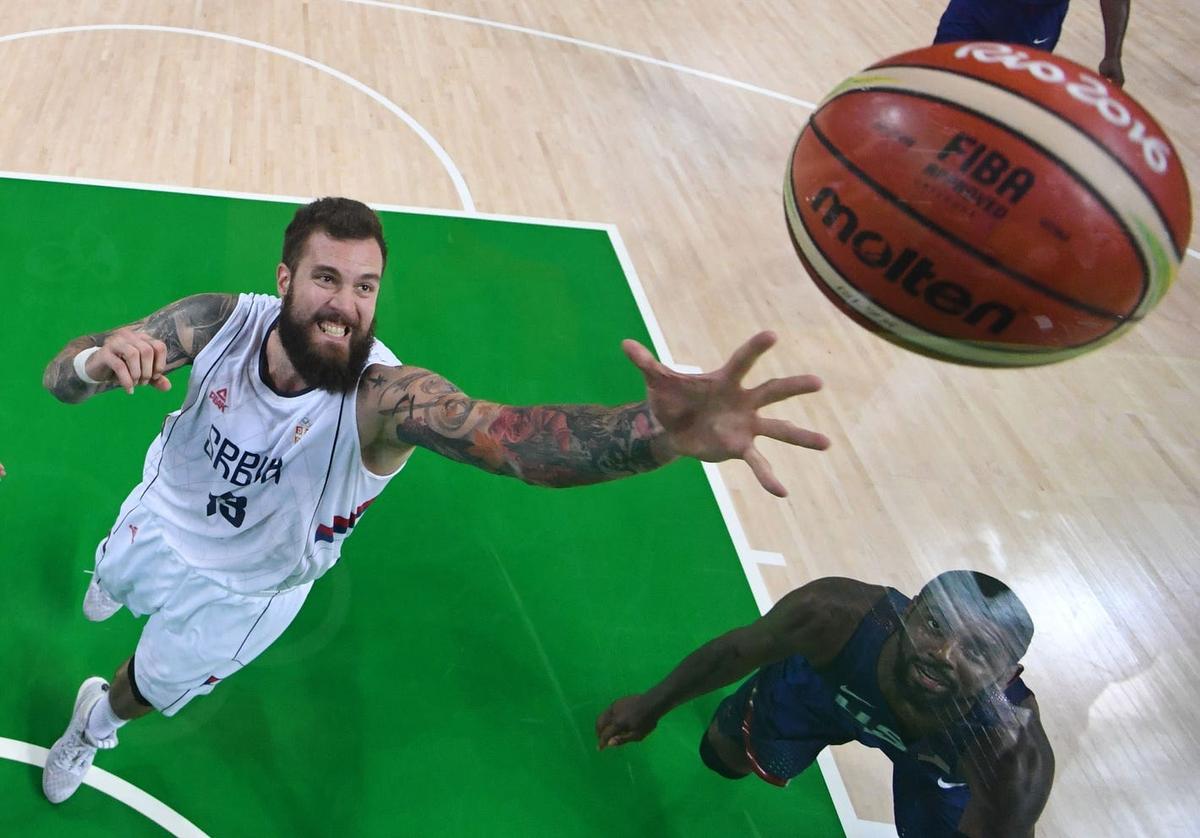 Aug 21, 2016; Rio de Janeiro, Brazil; Serbia center Miroslav Raduljica (13) reaches for the ball against USA during the gold medal men's basketball game during the Rio 2016 Summer Olympic Games at Carioca Arena 1. Mandatory Credit: David E. Klutho-USA TODAY Sports