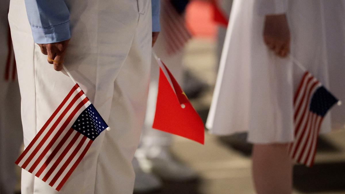 Chinese youth prepare for the arrival ceremony of U.S. President Donald Trump at Beijing Capital International Airport during his visit to the country, in Beijing, China, May 13, 2026. REUTERS/Evan Vucci