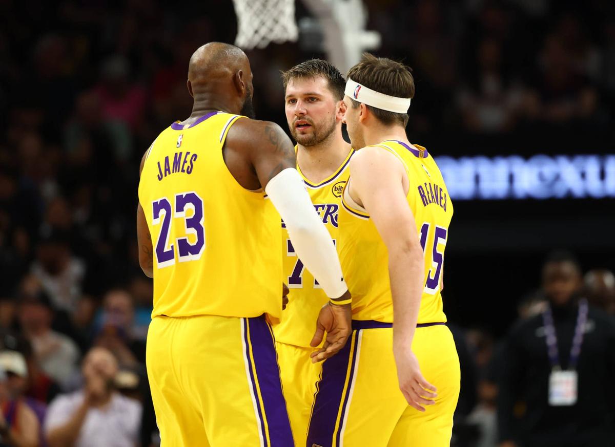  Los Angeles Lakers forward LeBron James (23) with guard Luka Doncic (77) and guard Austin Reaves (15). Mark J. Rebilas-Imagn Images