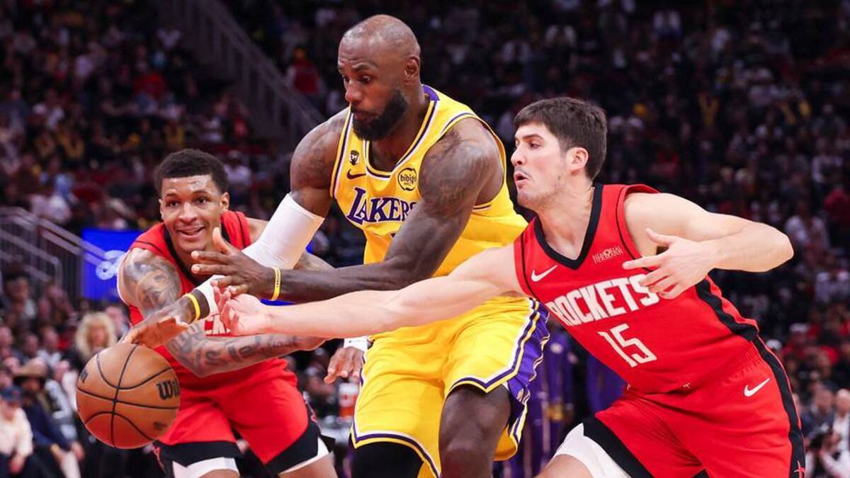  Mar 16, 2026; Houston, Texas, USA; Los Angeles Lakers forward LeBron James (23) and Houston Rockets forward Jabari Smith Jr. (10) and guard Reed Sheppard (15) for the ball during the fourth quarter at Toyota Center. Mandatory Credit: Troy Taormina-Imagn Images | IMAGN IMAGES via Reuters Connect 