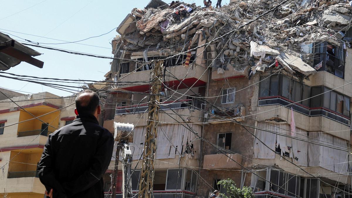 A man watches as rescuers work at the site of an Israeli strike that took place yesterday, in the southern suburbs of Beirut, Lebanon, May 7, 2026. REUTERS/Mohamad Azakir