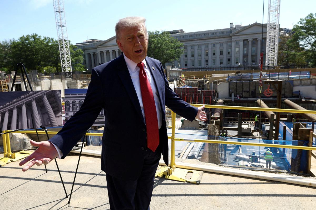 FILE PHOTO: U..S. President Donald Trump gestures at the site of ongoing construction of the planned White House ballroom in Washington, D.C., U.S., May 19, 2026. REUTERS/Kevin Lamarque