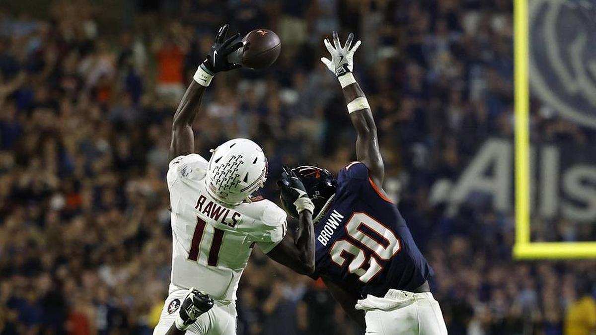  Sep 26, 2025; Charlottesville, Virginia, USA; Florida State Seminoles defensive back Ja'Bril Rawls (11) attempts to catch a pass intended for Virginia Cavaliers running back Xavier Brown (20) at Scott Stadium. Mandatory Credit: Geoff Burke-Imagn Images | Geoff Burke-Imagn Images 
