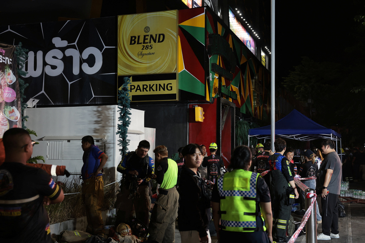 Members of emergency personnel work at the site of a deadly fire at a pub in Bangkok, Thailand, July 13, 2026. REUTERS/Chalinee Thirasupa