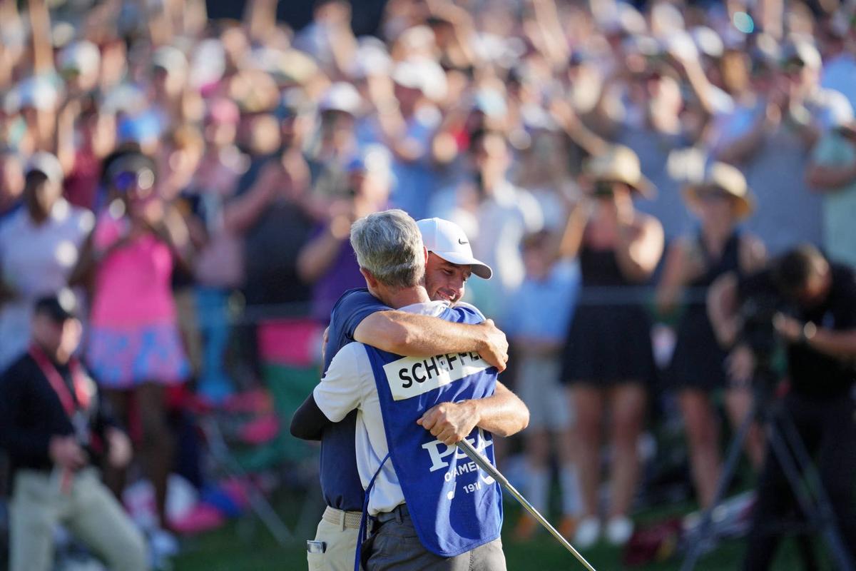  Scottie Scheffler celebrates with his caddie, Ted Scott, after winning the PGA Championship at Quail Hollow in Charlotte, North Carolina, on May 18, 2025. Aaron Doster-Imagn Images