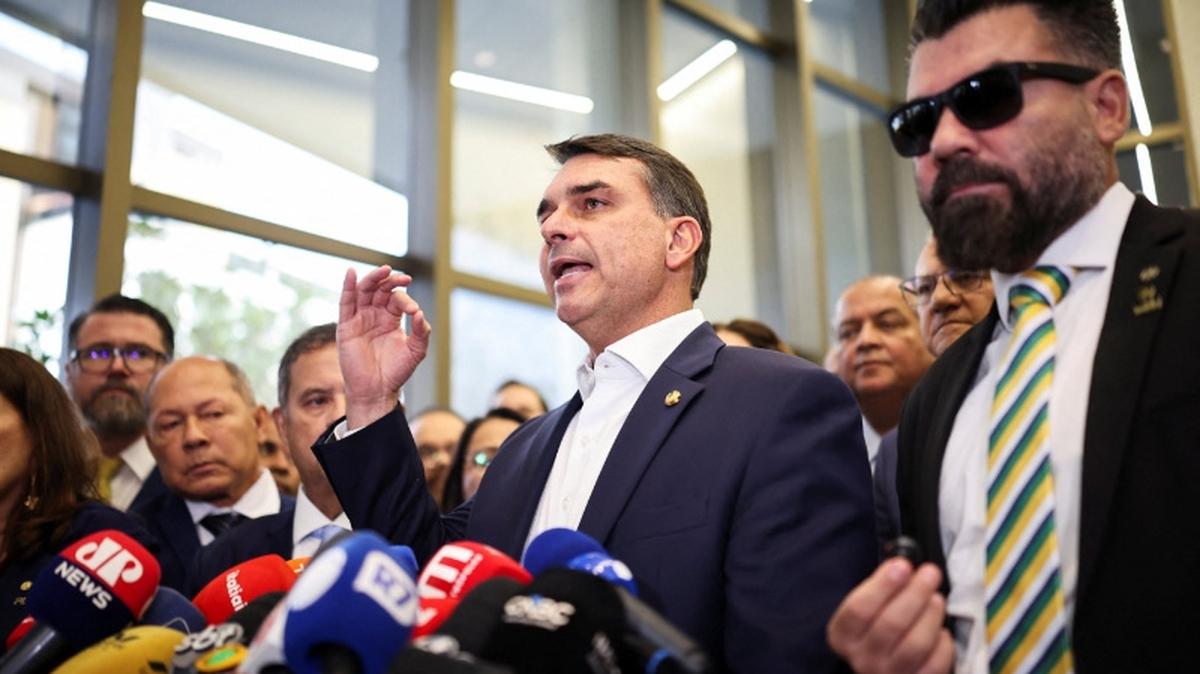 Flavio Bolsonaro speaks with members of the press after a meeting, following a scandal over messages tied to his request for funding for a biopic about former Brazilian President Jair Bolsonaro, from disgraced banker Daniel Vorcaro, who was arrested in March on suspicion of leading a multibillion-dollar fraud scheme, in Brasilia, Brazil, May 19, 2026. REUTERS/Mateus Bonomi