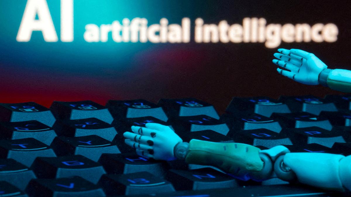 FILE PHOTO: A message reading "AI artificial intelligence," a keyboard and robot hands are seen in this illustration created on January 27, 2025. REUTERS/Dado Ruvic/Illustration//File Photo