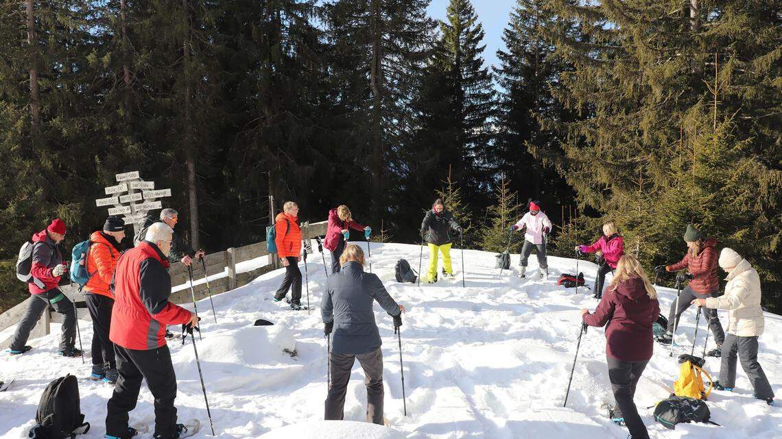 Snowshoe yoga above the clouds in Austria's snow-capped mountains