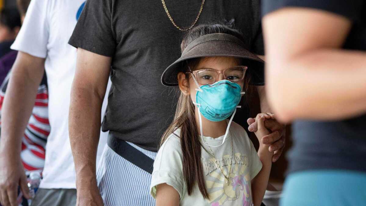 Seven-year-old Coral Deanda waits patiently for an air purifier during an event hosted by Via Care Community Health Center at Our Lady of Victory Catholic Church in Los Angeles on Tuesday, June 23, 2026. (Photo by Drew A. Kelley, Press-Telegram/SCNG)