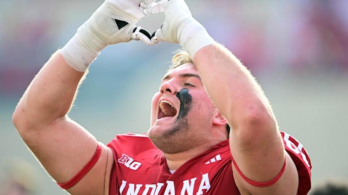  Nov 15, 2025; Bloomington, Indiana, USA; Indiana Hoosiers offensive lineman Carter Smith (65) makes a heart shape toward the student section after the game against the Wisconsin Badgers at Memorial Stadium. Mandatory Credit: Marc Lebryk-Imagn Images | Marc Lebryk-Imagn Images 