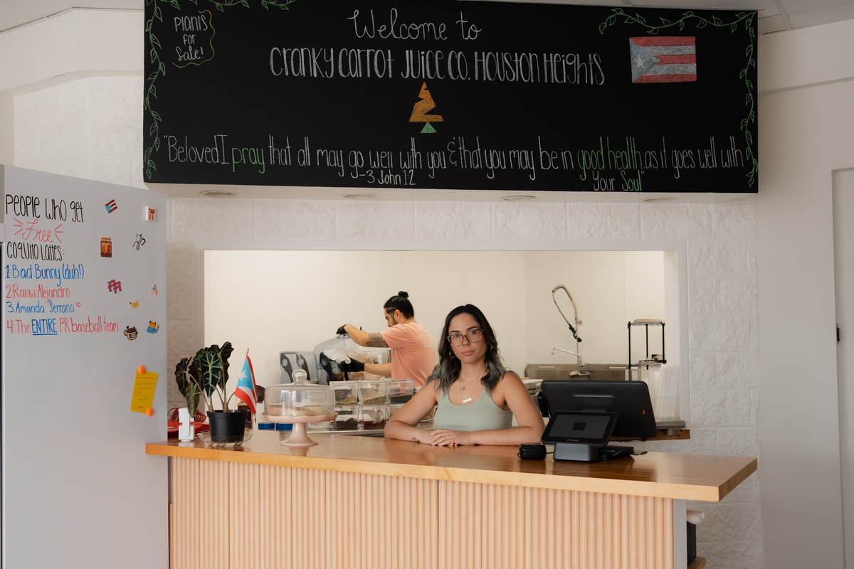 Francesca Costa, at her cafe Cranky Carrot Juice, in Houston on June 16, 2026. Small businesses say relentless pressures from tariffs and higher energy prices have sapped their resilience and finances; Costa has already raised menu prices once this year -- cold-pressed juices by 50 cents, smoothies by $1 -- and is hesitant to do so again when consumers are pulling back. (Hope Mora/The New York Times).