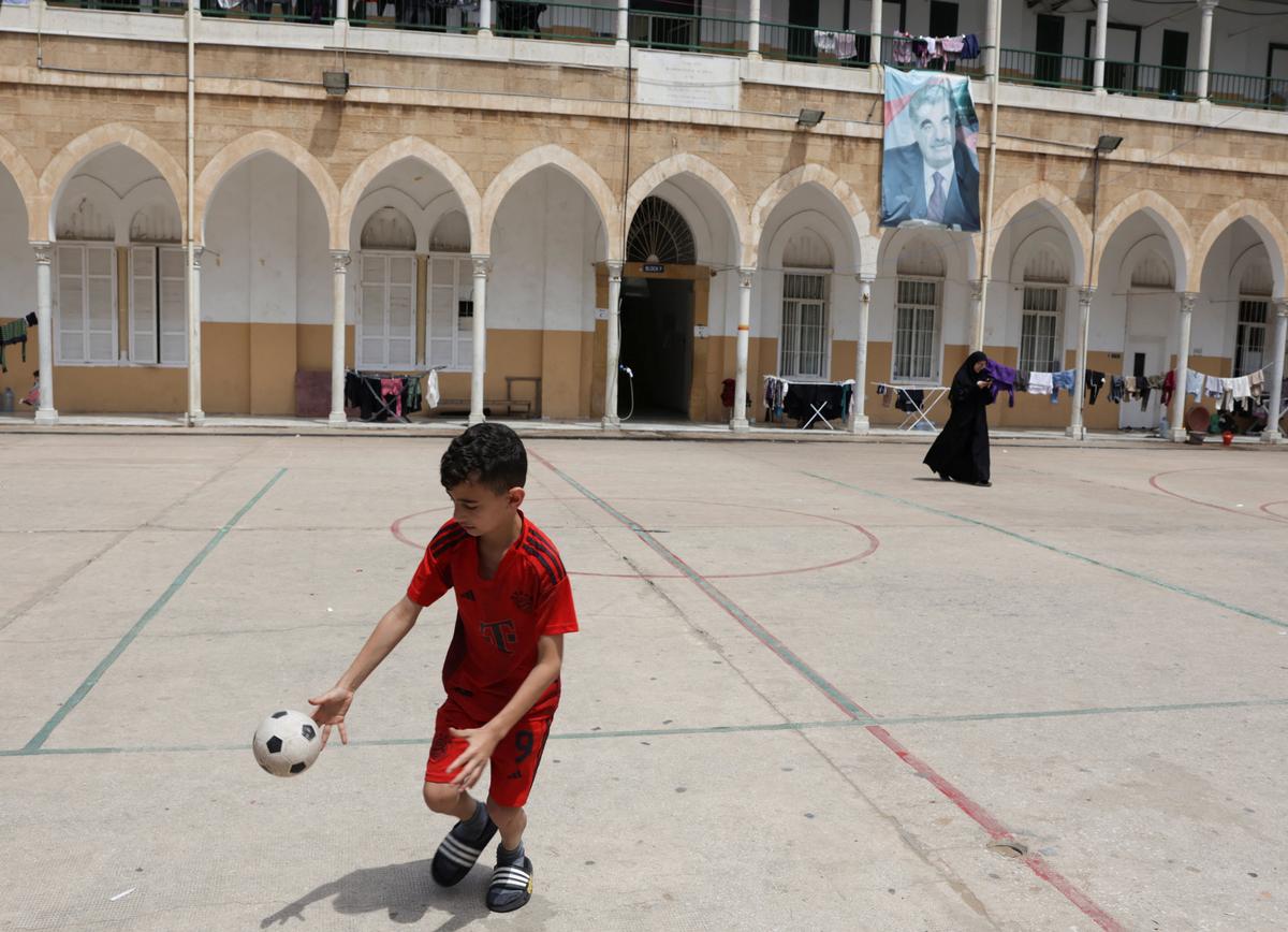 A child plays in the yard of a school used as a temporary shelter for displaced people, in Beirut, Lebanon, May 2, 2026. REUTERS/ Raghed Waked