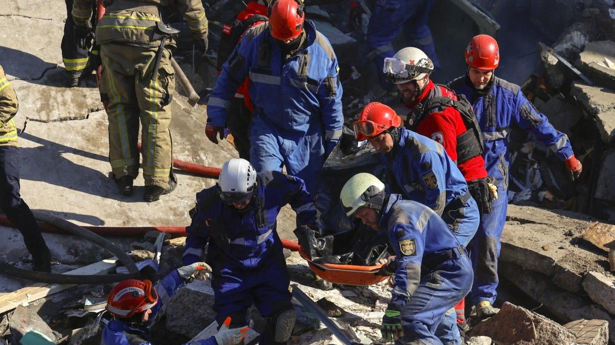 Ukrainian rescuers carry the body of a victim after a nine-story residential building was hit by an overnight Russian attack in Kyiv, Ukraine, Thursday. At least 24 were killed and dozens more injured. Photo by Mykola Tymchenko/EPA