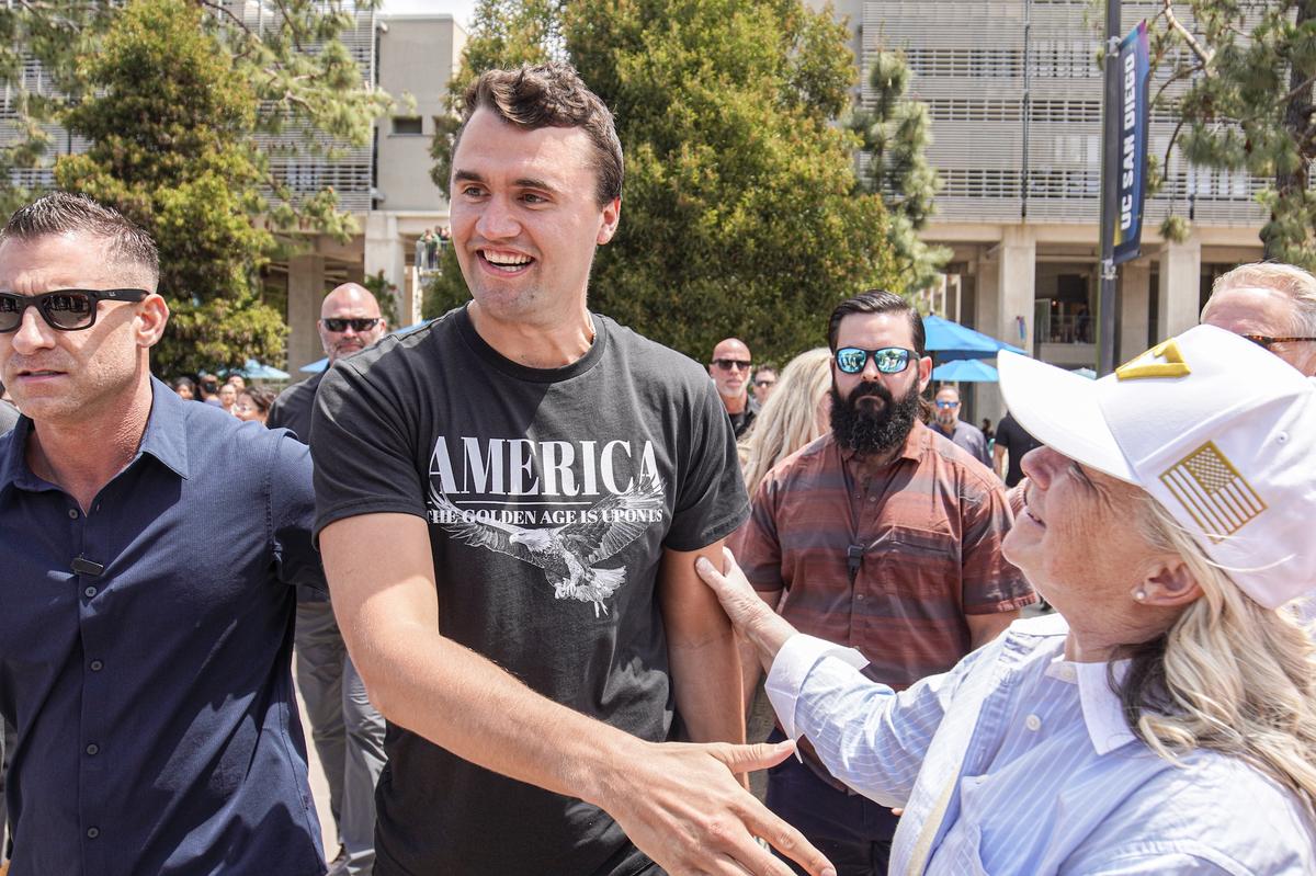 SAN DIEGO, CALIFORNIA, UNITED STATES - 2025/05/01: Charlie Kirk, founder of Turning Point USA, enters the plaza and talks with his supporters. Turning Point USA founder and American conservative political activist, Charlie Kirk sets up in UC San Diego’s Town Square fielding rapid-fire questions from students and community members in a signature “change-my-mind”-style forum, while campus police and private security ring the perimeter to keep the busy plaza orderly. (Photo by Michael Ho Wai Lee/SOPA Images/LightRocket via Getty Images)