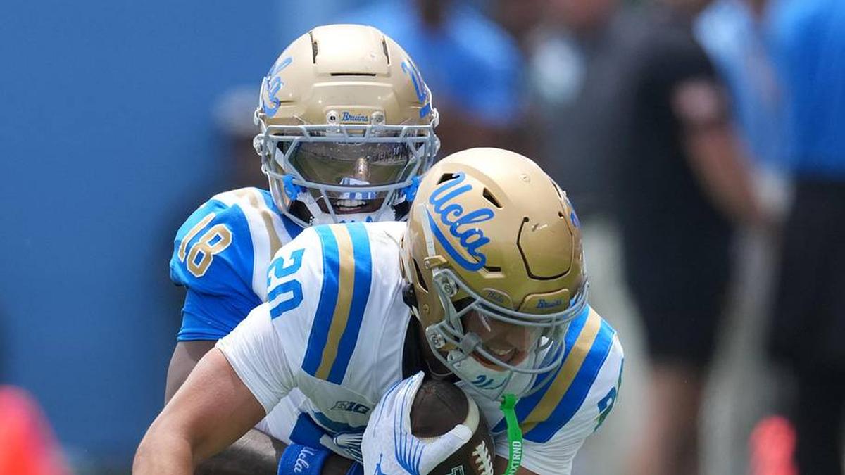  May 2, 2026; Pasadena, CA, USA; UCLA Bruins defensive back Osiris Gilbert (18) tackles receiver Shane Rosenthal (20) during the spring game at Rose Bowl. Mandatory Credit: Kirby Lee-Imagn Images | Kirby Lee-Imagn Images 