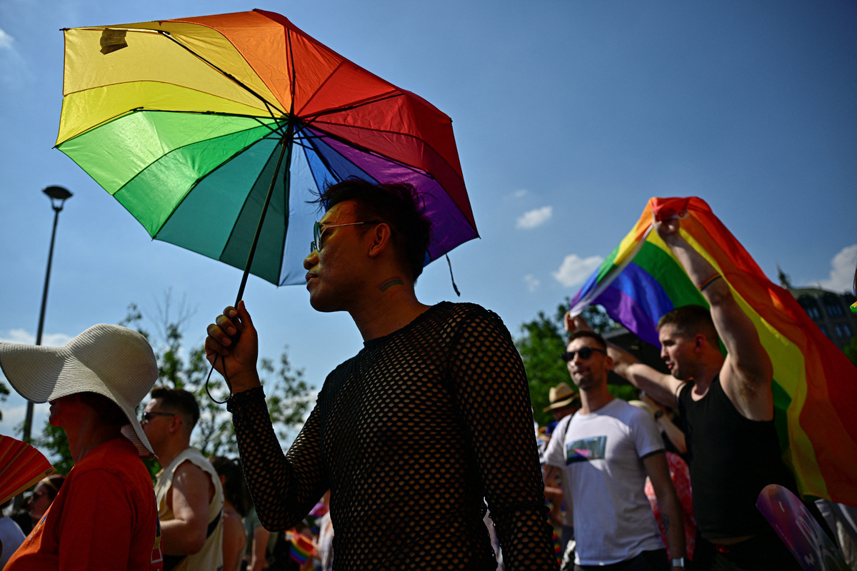 A person holds an umbrella in the colors of a Pride flag as people attend the Budapest Pride march in Budapest, Hungary, June 27, 2026. REUTERS/Marton Monus