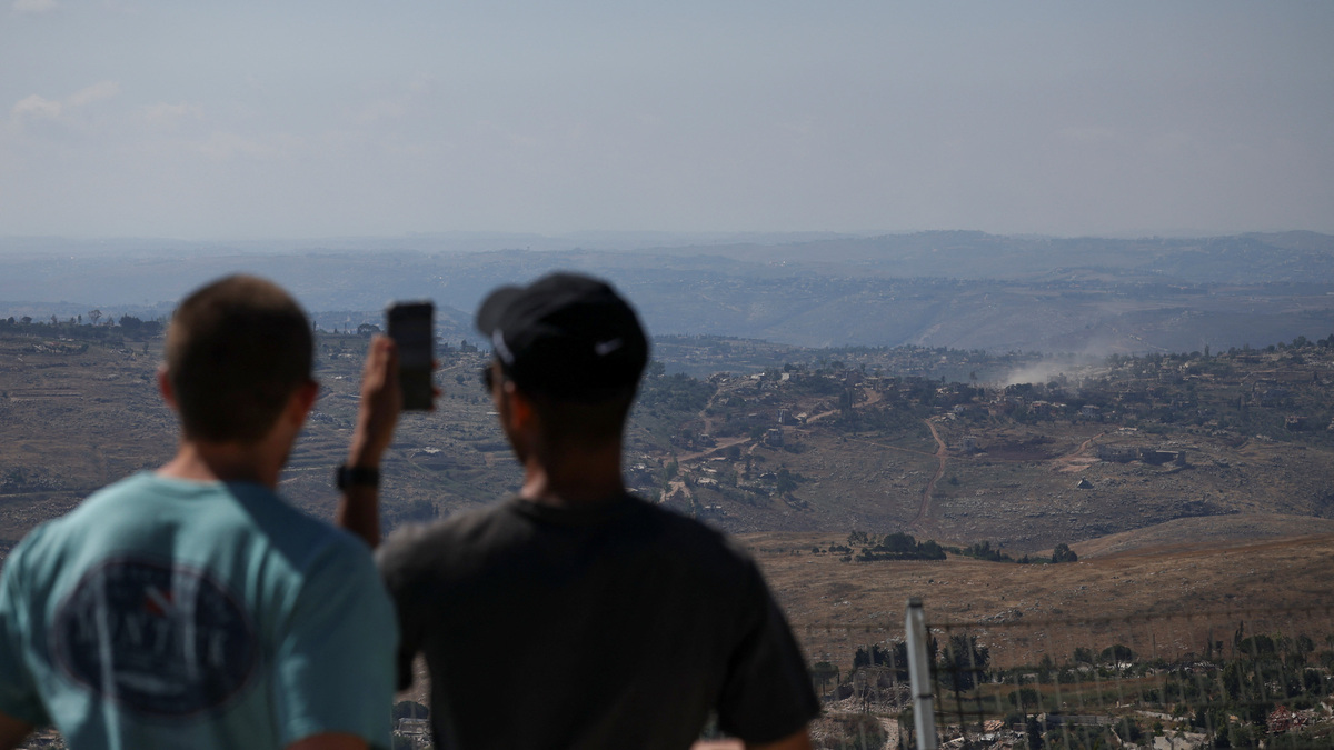 People look at smoke rising in southern Lebanon, as seen from the Israeli side of the Israel-Lebanon border, in northern Israel, June 17, 2026. REUTERS/Shir Torem