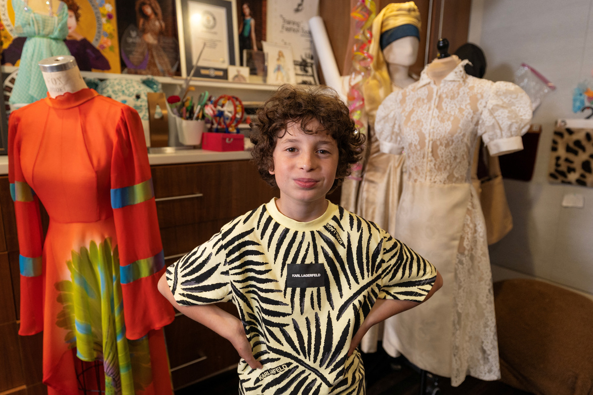 Max Alexander, 10, a fashion designer who recently debuted his first runway show in Paris, poses for a picture in his studio at his parents' home in Los Angeles, California, U.S., June 5, 2026. REUTERS/Mike Blake