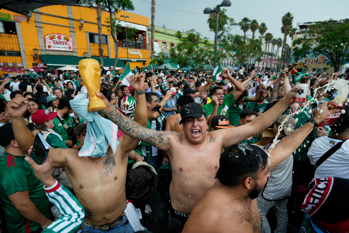 Fans celebrate Mexico's victory over South Africa during a public viewing of the opening game of the 2026 FIFA World Cup in Plaza Garibaldi, as many Mexicans say they feel excluded despite the tournament's return to the country, citing high ticket prices, paid television access and strict commercial restrictions, in Mexico City, Mexico, June 11, 2026. REUTERS/Armando Vega