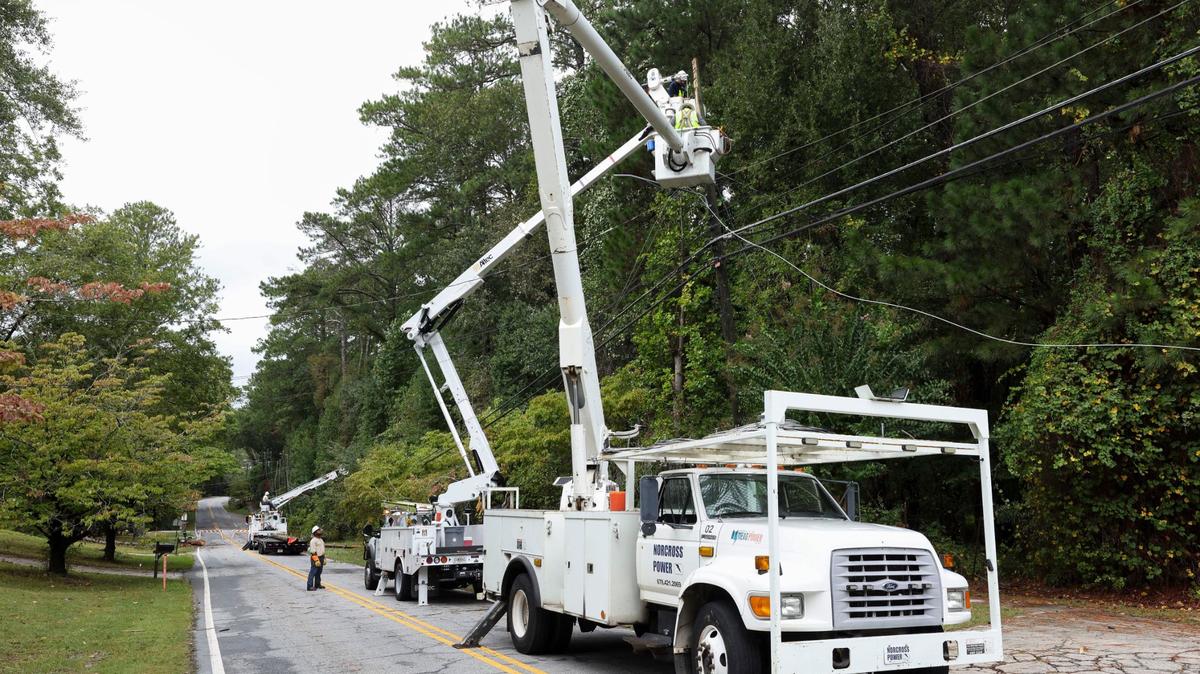 Crews with Norcross Power work on fixing down electrical lines on Holcomb Bridge Road, Friday, Sept. 27, 2024, in Norcross, Ga. Trees fell on the line after Hurricane Helene brought heavy rain and high winds across Georgia. (Jason Getz / AJC)