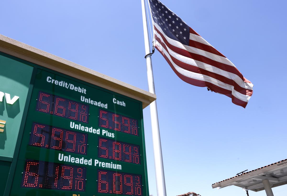  An American flag flies above gas prices displayed at a gas station on May 11, 2026 in Arcadia, California. 