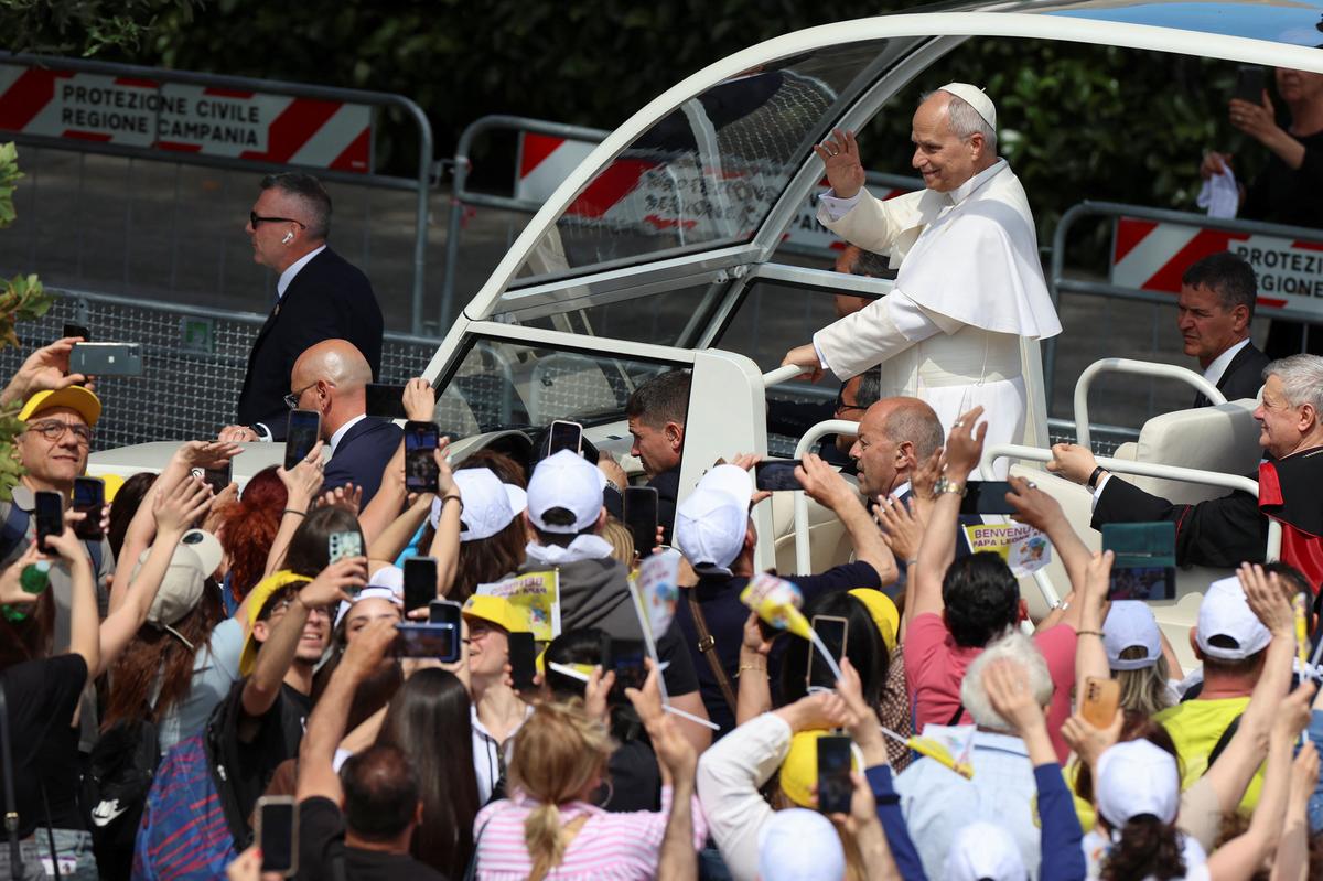 Pope Leo XIV waves as he arrives for a meeting with Mayors and faithful of various municipalities of the so-called "Land of Fires," an area long plagued by illegal toxic waste dumping and burning, at Piazza Nicola Calipari in Acerra, Italy, May 23, 2026. REUTERS/Ciro De Luca