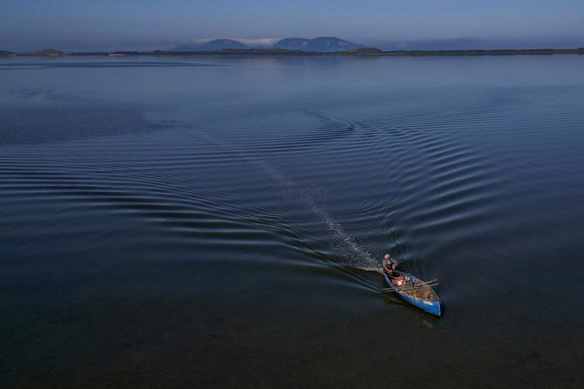 A drone view shows a fisherman sailing his boat near the Vjosa-Narta Protected Area, where a luxury resort is planned by a company linked to Donald Trump's son-in-law, Jared Kushner, in Zvernec near Vlora, Albania, June 10, 2026. REUTERS/Florion Goga