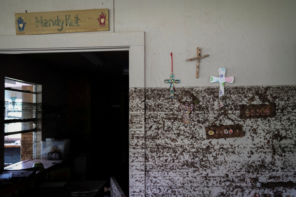 FILE PHOTO: Crosses hang from a wall with flood marks, following flooding on the Guadalupe River, at Camp Mystic, Hunt, Texas, U.S. July 7, 2025. REUTERS/Marco Bello/File Photo
