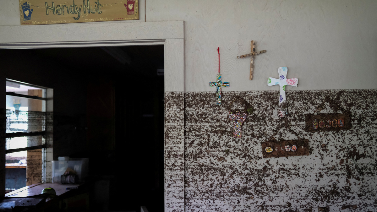 FILE PHOTO: Crosses hang from a wall with flood marks, following flooding on the Guadalupe River, at Camp Mystic, Hunt, Texas, U.S. July 7, 2025. REUTERS/Marco Bello/File Photo