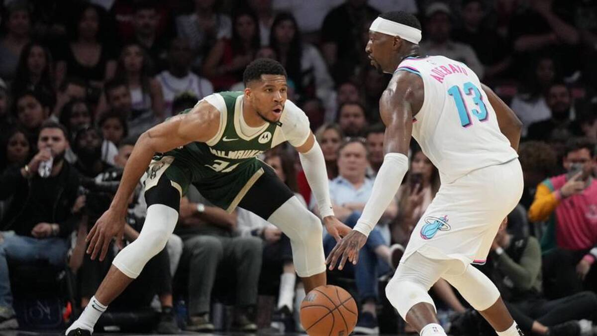  Apr 5, 2025; Miami, Florida, USA; Miami Heat center Bam Adebayo (13) looks to pass the ball as Milwaukee Bucks forward Giannis Antetokounmpo (34) defends during the second half at Kaseya Center. Mandatory Credit: Jim Rassol-Imagn Images | Jim Rassol-Imagn Images 