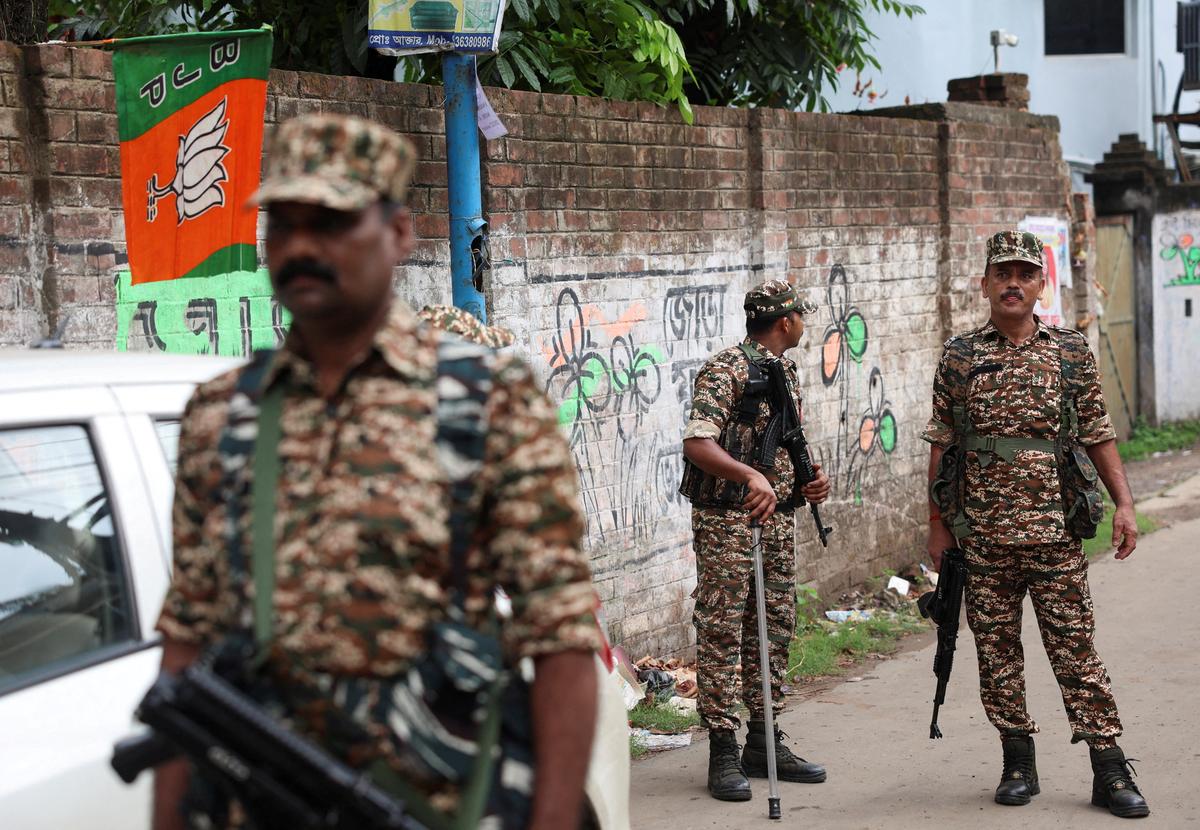 Members of security forces stand guard along a road leading to the site where an aide of Suvendu Adhikari, a leader of Bharatiya Janata Party (BJP) in West Bengal state, was shot dead days after the BJP secured a majority in the state assembly elections, in North 24 Parganas, on the outskirts of Kolkata, India, May 7, 2026. REUTERS/Sahiba Chawdhary