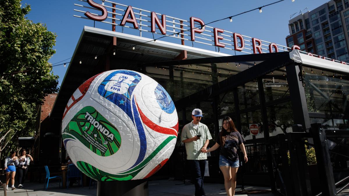 A large Trionda World Cup soccer ball installation sits outside San Pedro Square Market Monday, June 1, 2026, as people walk past in San Jose, Calif. (Dai Sugano/Bay Area News Group)