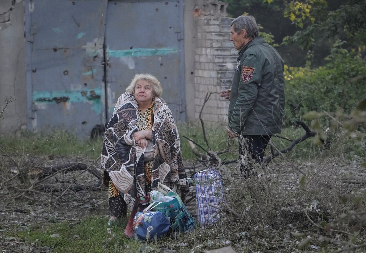 A woman sits near an apartment building damaged during a Russian drone and missile strike, amid Russia's attack on Ukraine, in Dnipro, Ukraine June 2, 2026. REUTERS/Stringer