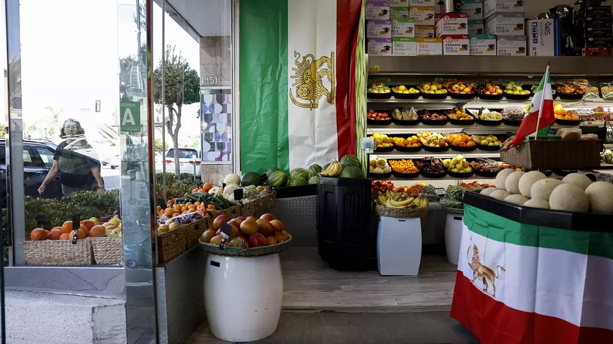 The flags of pre-revolution Iran are prominently displayed in the Jordan Market, a purveyor of Persian groceries on L.A.’s Westwood Boulevard, in April 2026. (Kayla Bartkowski/Los Angeles Times/TNS)