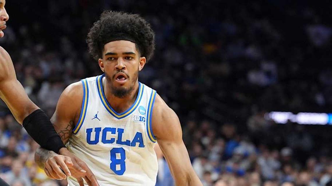  Mar 20, 2026; Philadelphia, PA, USA; UCLA Bruins guard Eric Freeny (8) dribbles the ball against UCF Knights forward Jamichael Stillwell (4) in the first half during a first round game of the men's 2026 NCAA Tournament at Xfinity Mobile Arena. Mandatory Credit: Kyle Ross-Imagn Images | Kyle Ross-Imagn Images 