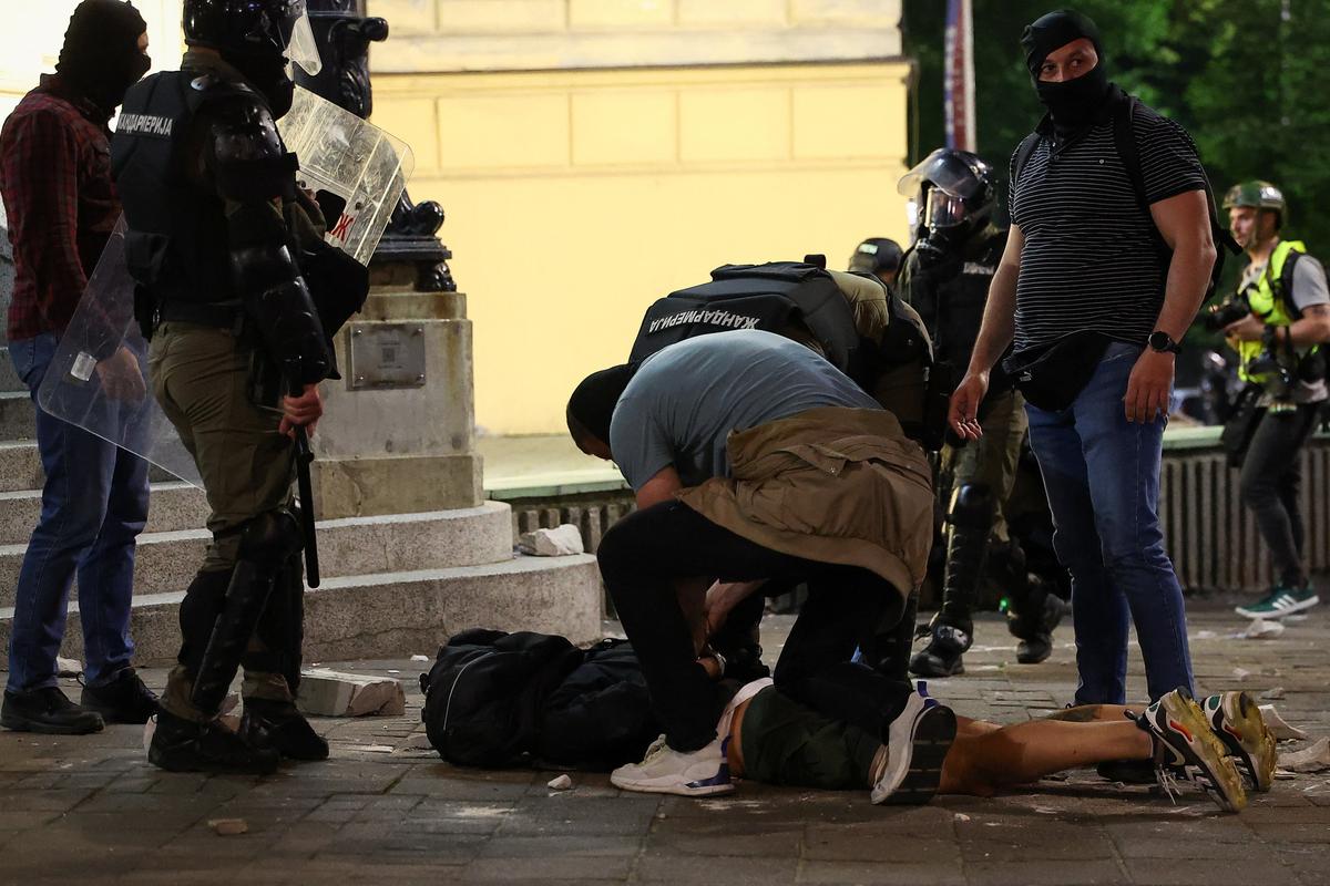 A demonstrator is handcuffed, during a student-led protest demanding snap parliamentary elections, as Serbia's anti-corruption movement enters a new phase, following the Novi Sad railway station canopy collapse that killed 16 people in 2024, in Belgrade, Serbia, May 23, 2026. REUTERS/Zorana Jevtic