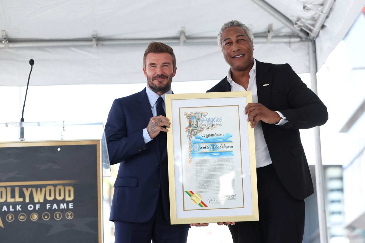 David Beckham receives a proclamation from the city of Los Angeles, as he unveils his star on the Hollywood Walk of Fame in Los Angeles, California, U.S., June 12, 2026. REUTERS/Mario Anzuoni