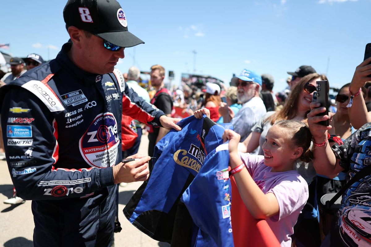  Kyle Busch signs an autograph for a fan at Texas Motor Speedway. (Photo by Logan Riely/Getty Images)