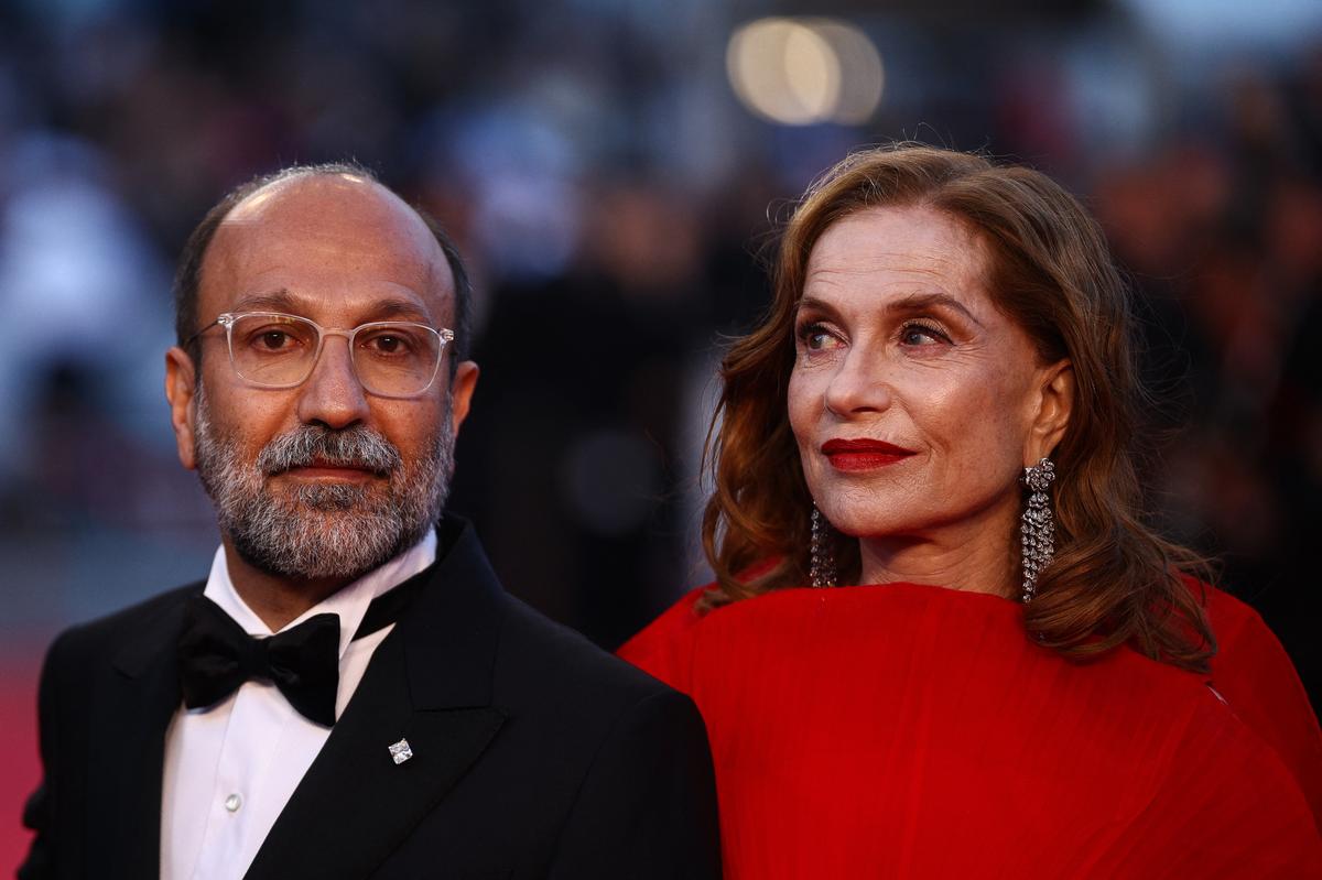 Director Asghar Farhadi and cast member Isabelle Huppert pose on the red carpet during arrivals for the screening of the film "Histoires paralleles" (Parallel Tales) in competition at the 79th Cannes Film Festival in Cannes, France, May 14, 2026. REUTERS/Marko Djurica