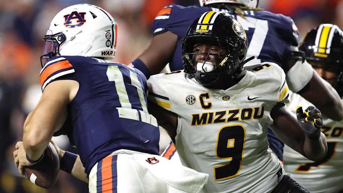 Oct 18, 2025; Auburn, Alabama, USA; Missouri Tigers defensive end Zion Young (9) moves in to tackle Auburn Tigers quarterback Jackson Arnold (11) during the fourth quarter at Jordan-Hare Stadium. Mandatory Credit: John Reed-Imagn Images | John Reed-Imagn Images 