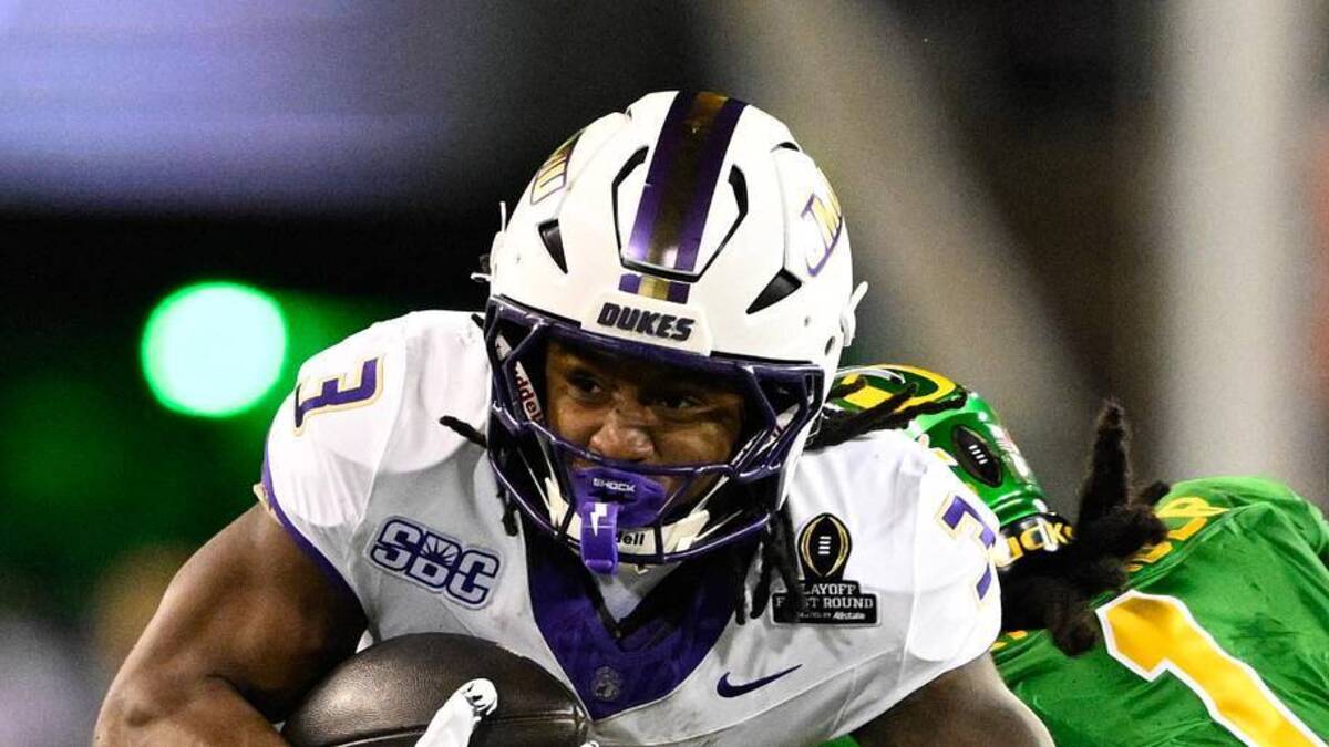  Dec 20, 2025; Eugene, OR, USA; James Madison Dukes running back Wayne Knight (3) rushes as Oregon Ducks defensive back Aaron Flowers (21) defends during the second quarter at Autzen Stadium. Mandatory Credit: Troy Wayrynen-Imagn Images | Troy Wayrynen-Imagn Images 