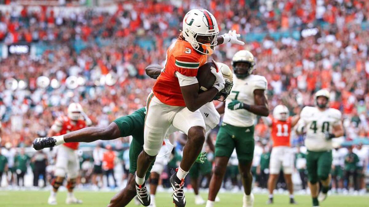  Sep 13, 2025; Miami Gardens, Florida, USA; Miami Hurricanes wide receiver Joshua Moore (3) runs into the end zone for a touchdown against the South Florida Bulls in the first quarter at Hard Rock Stadium. Mandatory Credit: Nathan Ray Seebeck-Imagn Images | IMAGN IMAGES via Reuters Connect 