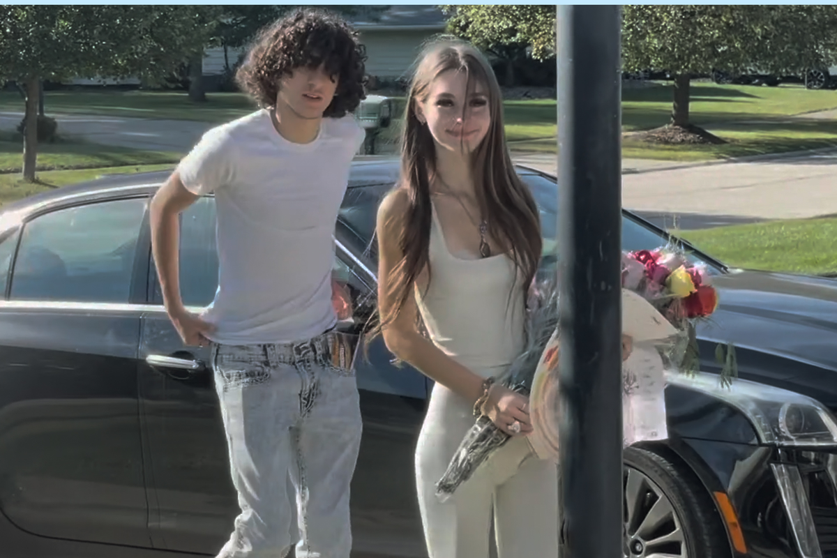  Dominic “Dom” Russo and Mackenzie Shirilla, holding flowers, stand by a car in The Crash. 