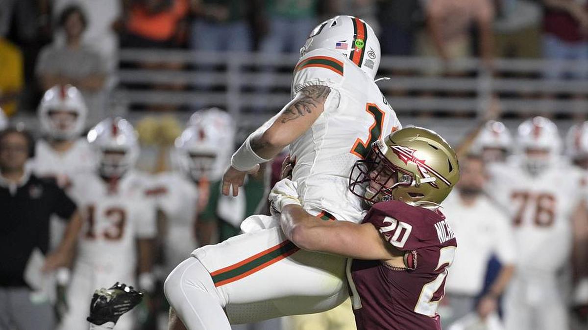  Oct 4, 2025; Tallahassee, Florida, USA; Miami Hurricanes quarterback Carson Beck (11) is tackled by Florida State Seminoles linebacker Blake Nichelson (20) during the first half at Doak S. Campbell Stadium. Mandatory Credit: Melina Myers-Imagn Images | Melina Myers-Imagn Images 