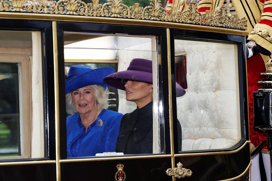 Queen Camilla and U.S. first lady Melania Trump sit in a carriage during a procession through Windsor Castle during the state visit by the President of the United States of America on September 17, 2025 in Windsor, England.