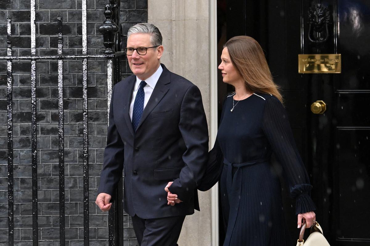 British Prime Minister Keir Starmer and his wife Victoria Starmer walk on Downing Street, on the day of the State Opening of Parliament, in London, Britain, May 13, 2026. REUTERS/Jaimi Joy