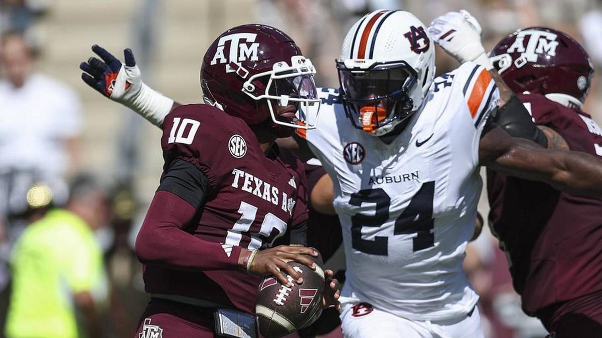  Sep 27, 2025; College Station, Texas, USA; Texas A&M Aggies quarterback Marcel Reed (10) looks for an open receiver as Auburn Tigers defensive end Keyron Crawford (24) applies defensive pressure during the second quarter at Kyle Field. Mandatory Credit: Troy Taormina-Imagn Images | Troy Taormina-Imagn Images 